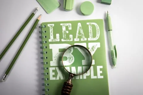 Lead by Example Message on Notebook With Magnifying Glass on Desk Stock Photos