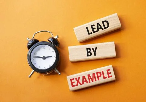 Lead by Example symbol. Concept word Lead by Example on wooden cubes. Beaut.. Stock Photos