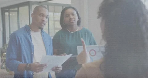 Lead gesturing, man reading papers, woman checking laptop charts, animated data Stock Footage 332468025