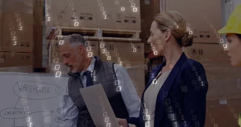 Lead leaning in and writing warehouse chart, urging peer with laptop checking Stock Footage 334311734