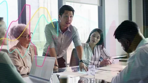 Lead leaning, pointing at charts, making moving data curves sweep over table Stock Footage 333287849