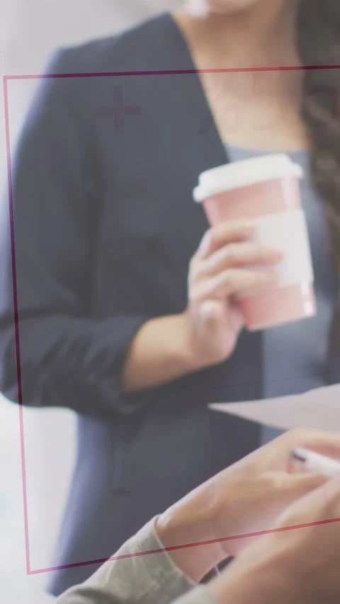 Lead pointing at doc, activating charts overlays while woman holding pink cup Stock Footage 332845791