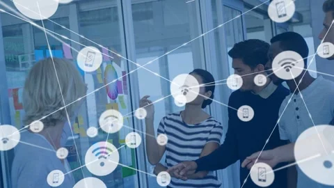 Lead pointing at notes on glass wall making node overlay linking them over team Stock Footage 332642412