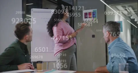 Lead pressing remote pointing at app mocks on glass showing data overlay writing Stock Footage 334179220