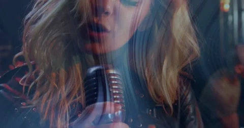 Lead singer performing song into mic frame widening light streaks sweeping face Stock-Footage 334112491