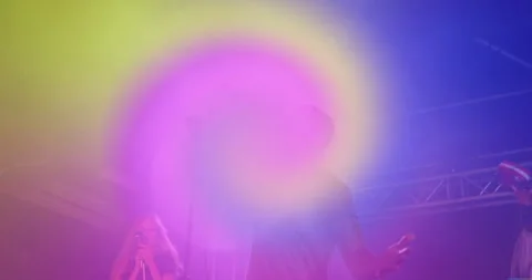 Lead singer raising arm on stage, initiating swirling rainbow spiral overlay Stock Footage 314656425