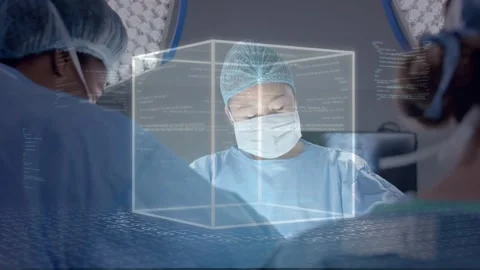 Lead surgeon operating in OR, software activating 3D cube annotating field, 库存影片 334694406