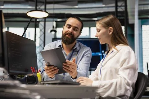 Lead technician providing support to new employee in software development agency Stock Photos