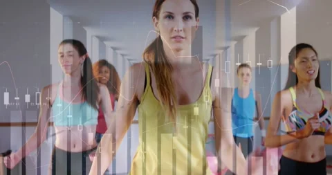 Lead trainer raising knees, urging class sync for cardio, camera zooming, Stock Footage 331614179