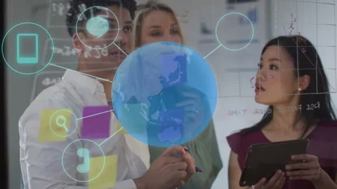 Lead writing on glass initiating tech globe and icons while tablet user Stock Footage 333004909