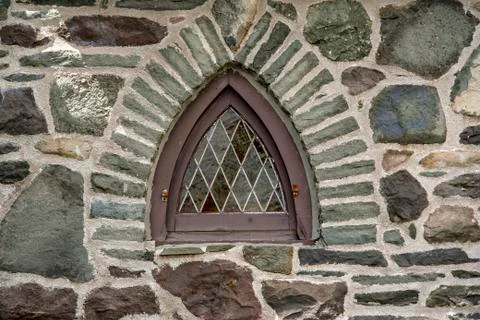 Leaded window in stone wall Stock Photos