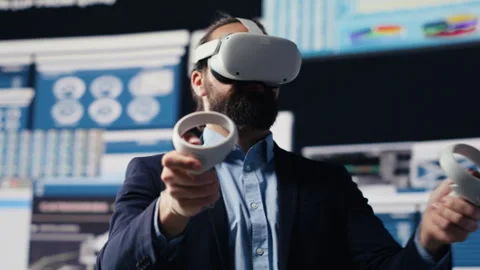 Leader does data driven planning with VR device set for successful strategy Stock Footage 311134487