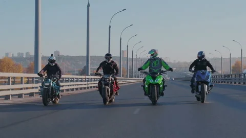 Leader of a group of moto drivers put hands up and having fun while moving. Stock Footage 105011664