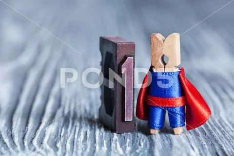 Leader superhero concept. Clothespin super hero and 1 one written with colored Stock Photos
