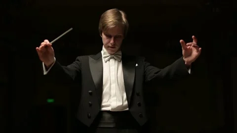 Leader of the symphony orchestra. Young conductor leads the orchestra Stock Footage 160715002
