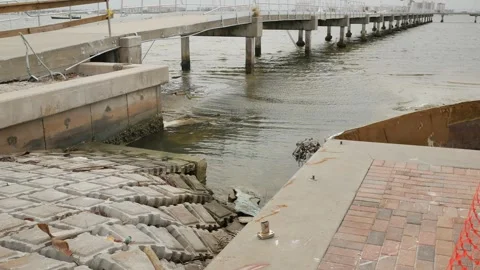 Leading lines to water Low angle view down a damaged rippled concrete boat ramp Stock Footage 291314527