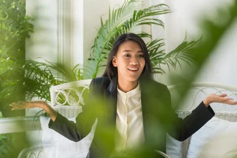 The leaf blurred in front of a beautiful young business woman raised her hand Stock Photos