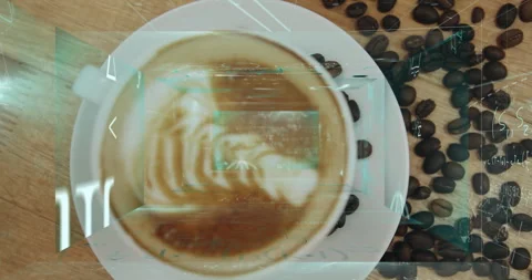 Leaf-pattern latte foam floating in ceramic cup on wooden table, coffee beans Stock Footage 307446722