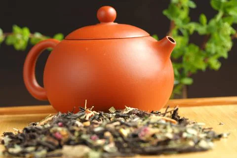 Leaf tea, willow tea, brewed in a clay brown teapot. Stock Photos
