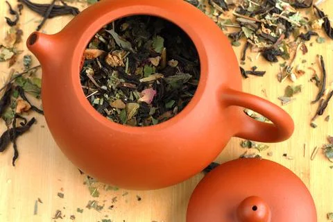 Leaf tea, willow tea, brewed in a clay brown teapot. Stock Photos