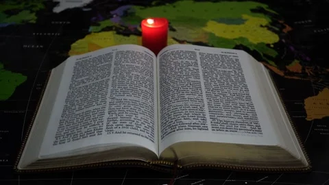 Leafing through the Bible with a Breath of the Wind On the World Map. Stock Footage 150125451