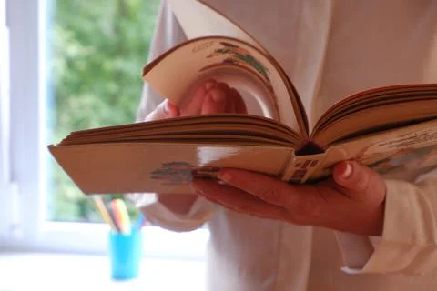 Leafing through the book on the background of the window. 1 September is the day Stock Photos