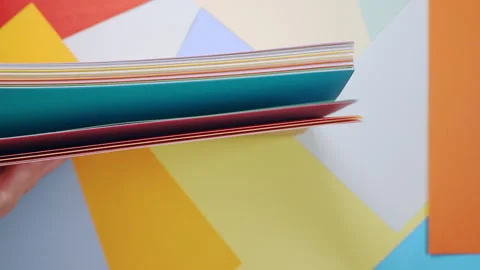 Leafing through ream of colored paper.mov Stock Footage