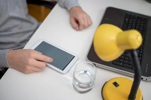 Leafing through the tape on the tablet Stock Photos