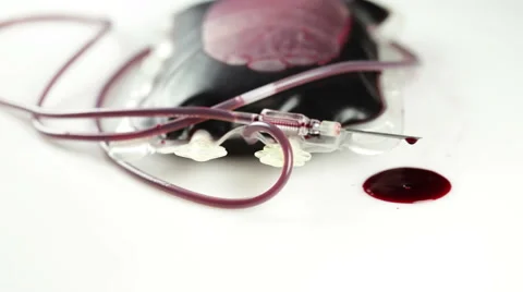 A leaking blood donation bag, needle and drops of blood Stock Footage