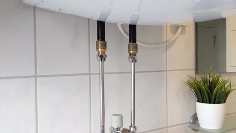 Leaking boiler pipe in modern bathroom Video stock 238726108