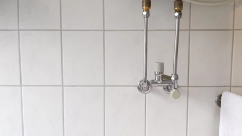 Leaking boiler pipe in modern bathroom Video stock 242602096