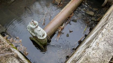 Leaking industrial pipe transporting the sewage water Stock Footage 119888098