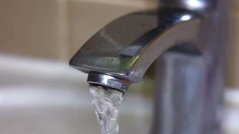 A Leaking Kitchen Faucet Dripping Water Waste in a Modern Residential Home Stock Footage 337429506