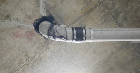 Leaking PVC pipe joint with sealant in concrete ceiling Stock Footage 332744661