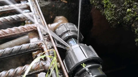 The leaks on the hdpe pipe size 1 inch on the drain have been spraying water. Stock Footage 121067033