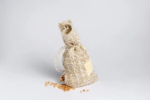 Leaky sack with grain on a white background Stock Photos