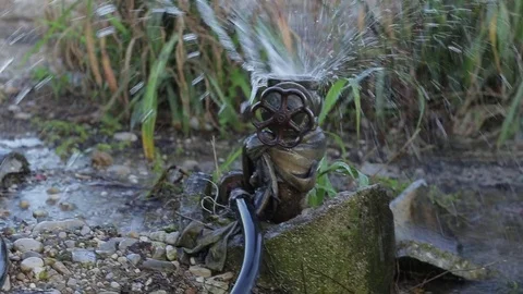 Leaky valve in arid fields wasting water Stock Footage 77957089