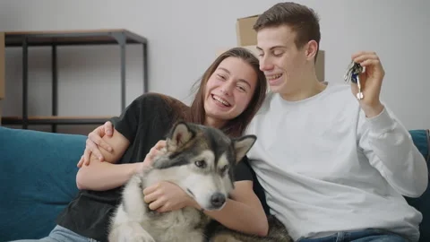 A lean man gently hugs his cheerful girlfriend. A man and a woman are sitting on Stock Footage 150351217