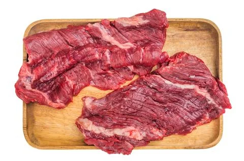 Lean raw beef bavette flap steak isolated on wooden board. Professional ove.. Stock Photos