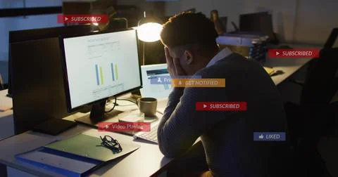 Leaning analyst in dark sweater analyzing charts on 2 monitors at office, 스톡 사진