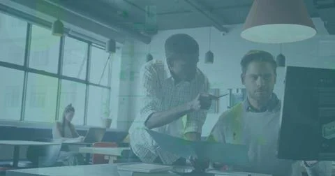 Leaning Black worker pointing at computer screen while manager reviewing folder Stock Photos