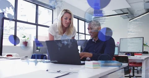 Leaning colleagues in white blouse and navy shirt discussing laptop in office Stock Footage 334036057