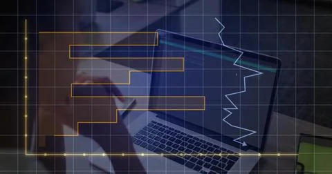 Leaning developer reviewing laptop code, graph at desk with papers and grid Stockfoto's