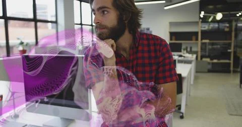 Leaning developer viewing purple wave projection at tech office with dual Stock Photos