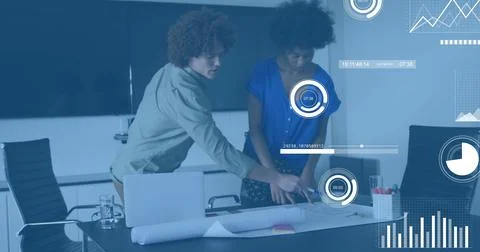 Leaning light-shirted man and blue-bloused woman pointing at blueprint in Stock Photos
