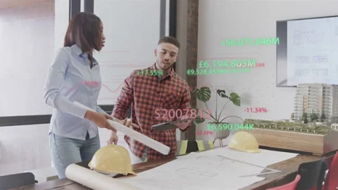 Leaning over plans at studio, blue-shirt woman, red-plaid man unrolling, using Stock Footage 332820847