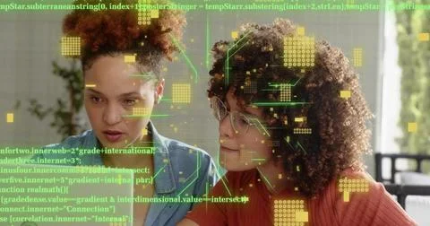 Leaning pair studying code in home-office on PC, wearing blue shirt, rust top, Foto stock