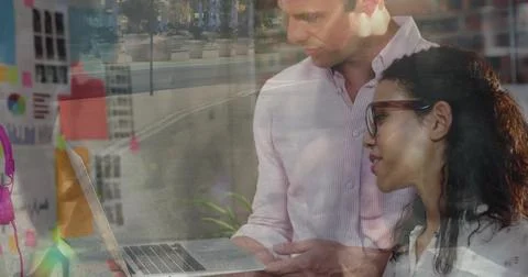 Leaning team at work, man in striped shirt holding laptop and reviewing sticky Stock Photos