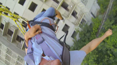 Leap forward with outstretched hand and then hang on the ropes Stock Footage 26637000