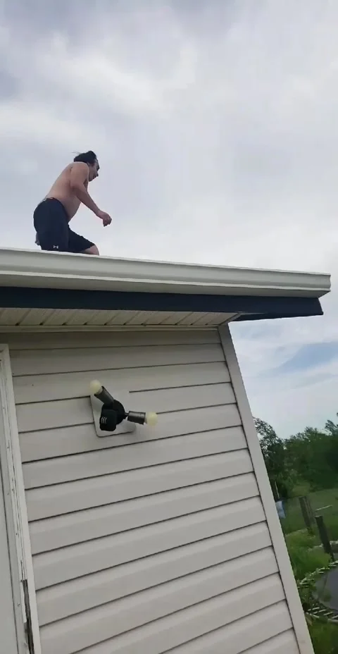 Leap from Rooftop to Trampoline Ends a Bit Short, PRINCE ALBERT, Saskatchewan, C Stock Footage 205165839